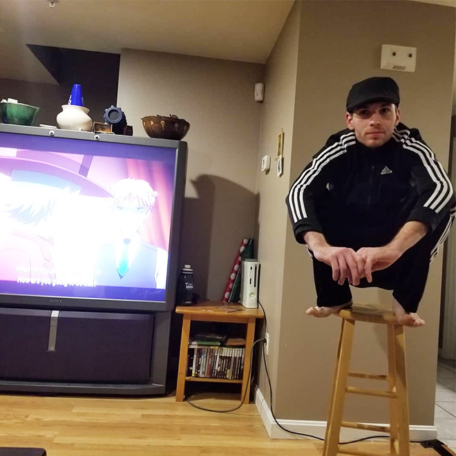 Squatting slav in a tracksuit.