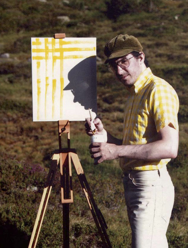 Artist visiting sceninc landscape to paint his own shirt.