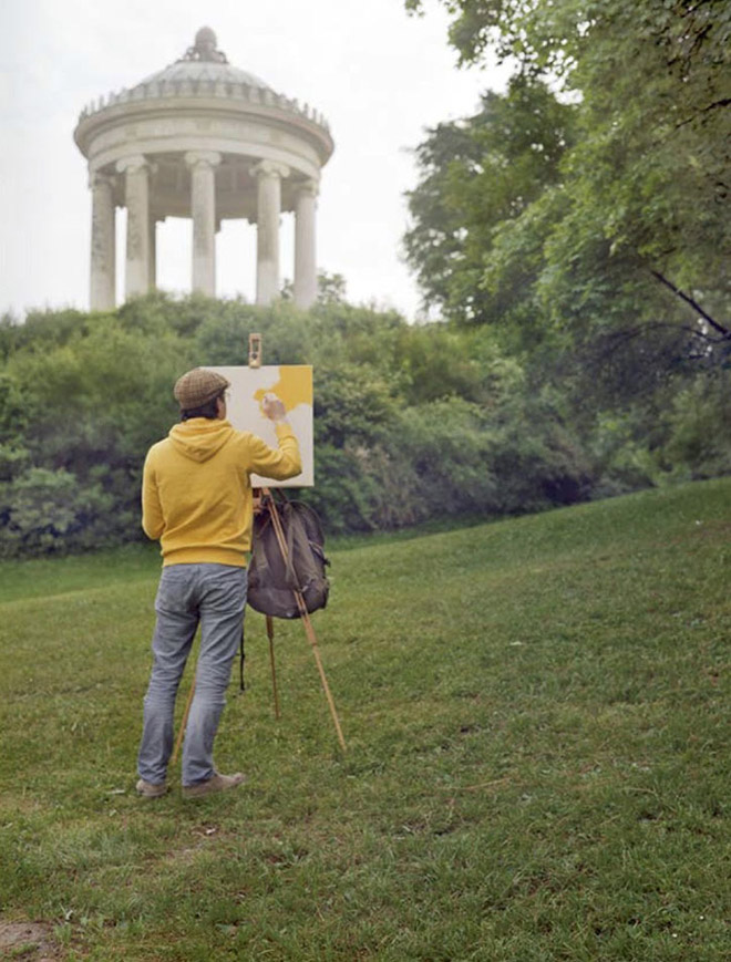 Artist visiting sceninc landscape to paint his own shirt.